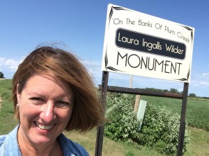 Posing by monument sign